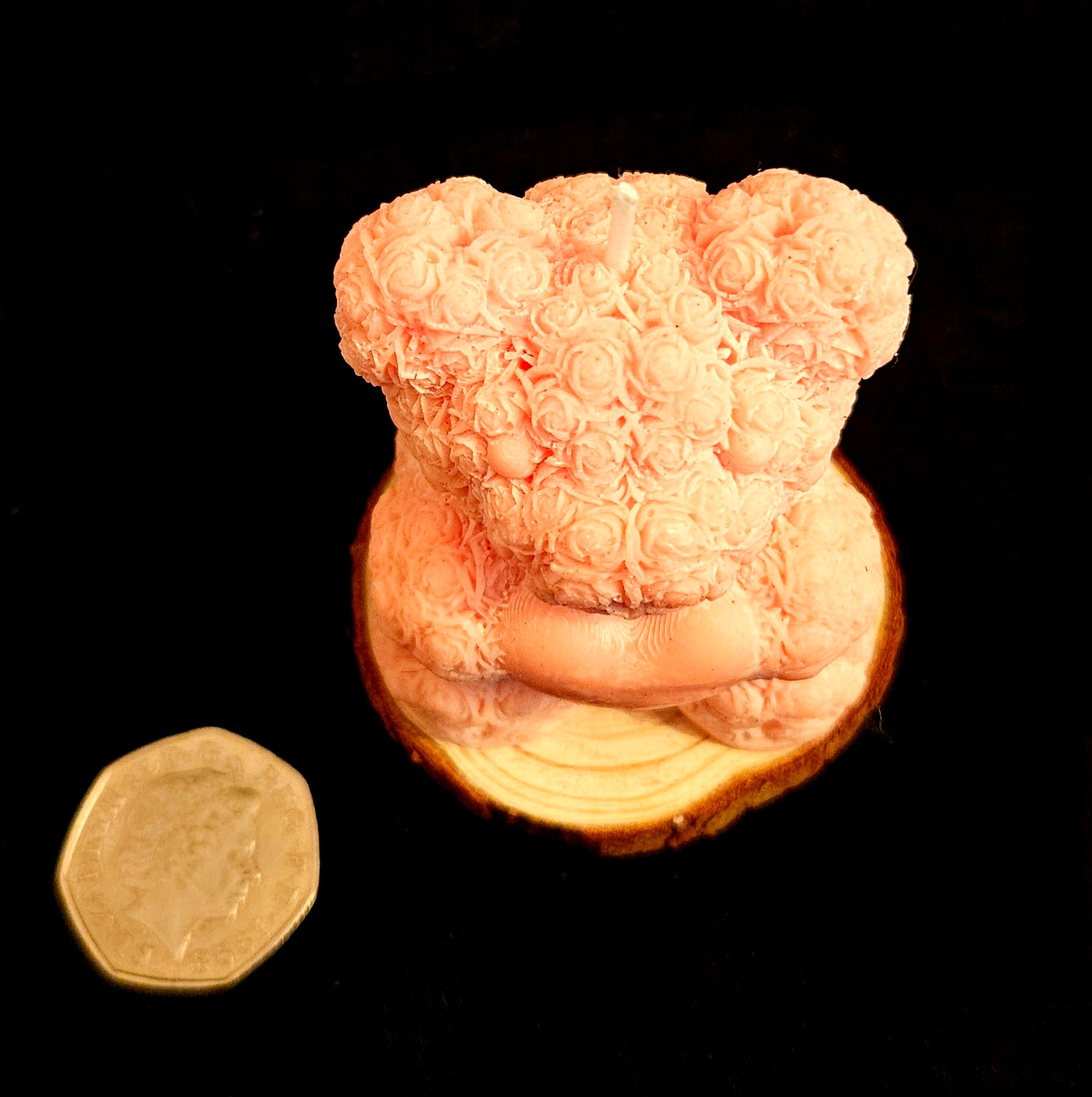 A charming handmade teddy bear crafted from flowers.
