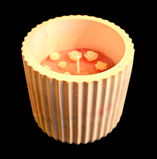 A delicately crafted, miniature floral candle.