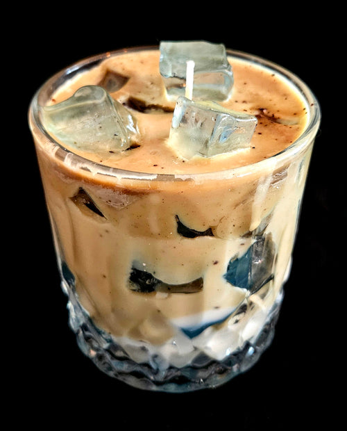 A delicately crafted candle that looks like a refreshing beverage with ice cubes and a subtle coffee aroma.