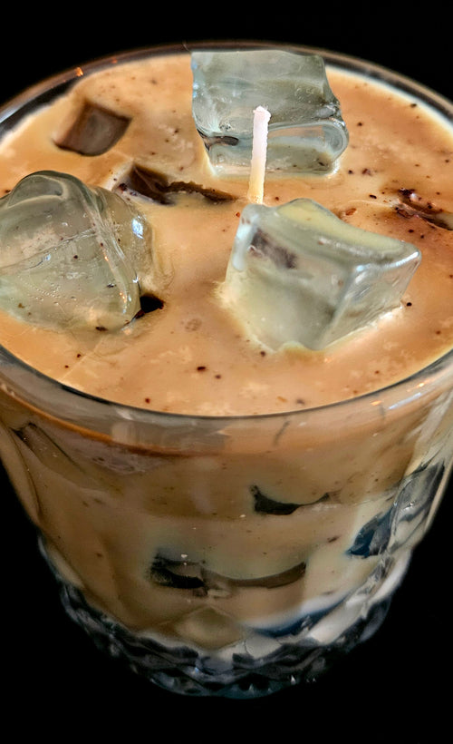 A delicately crafted candle that looks like a refreshing beverage with ice cubes and a subtle coffee aroma.