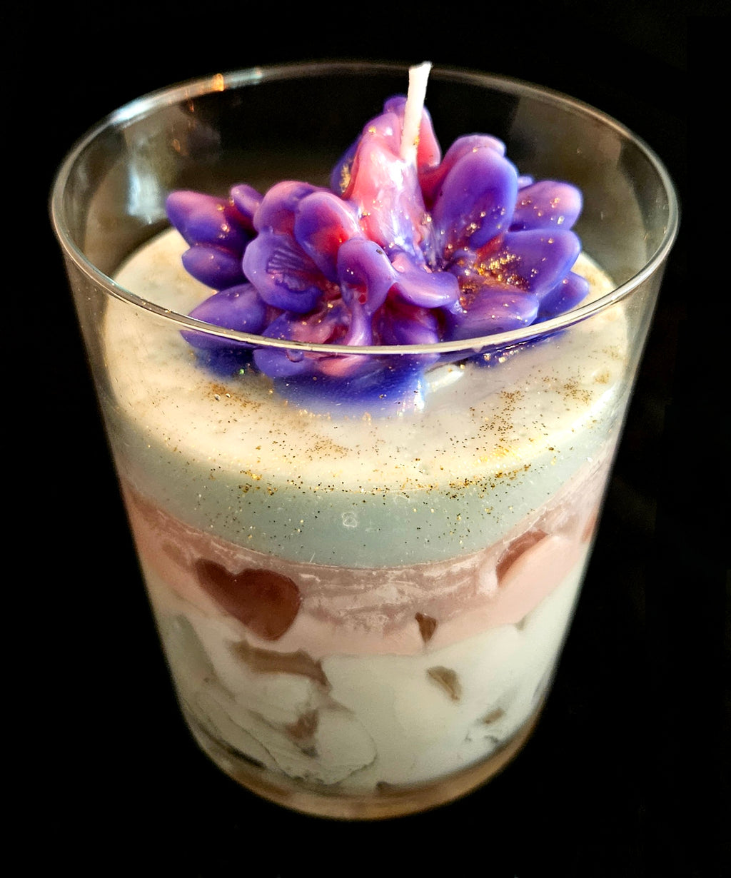 A handmade candle featuring jelly and soy wax, adorned with flowers.